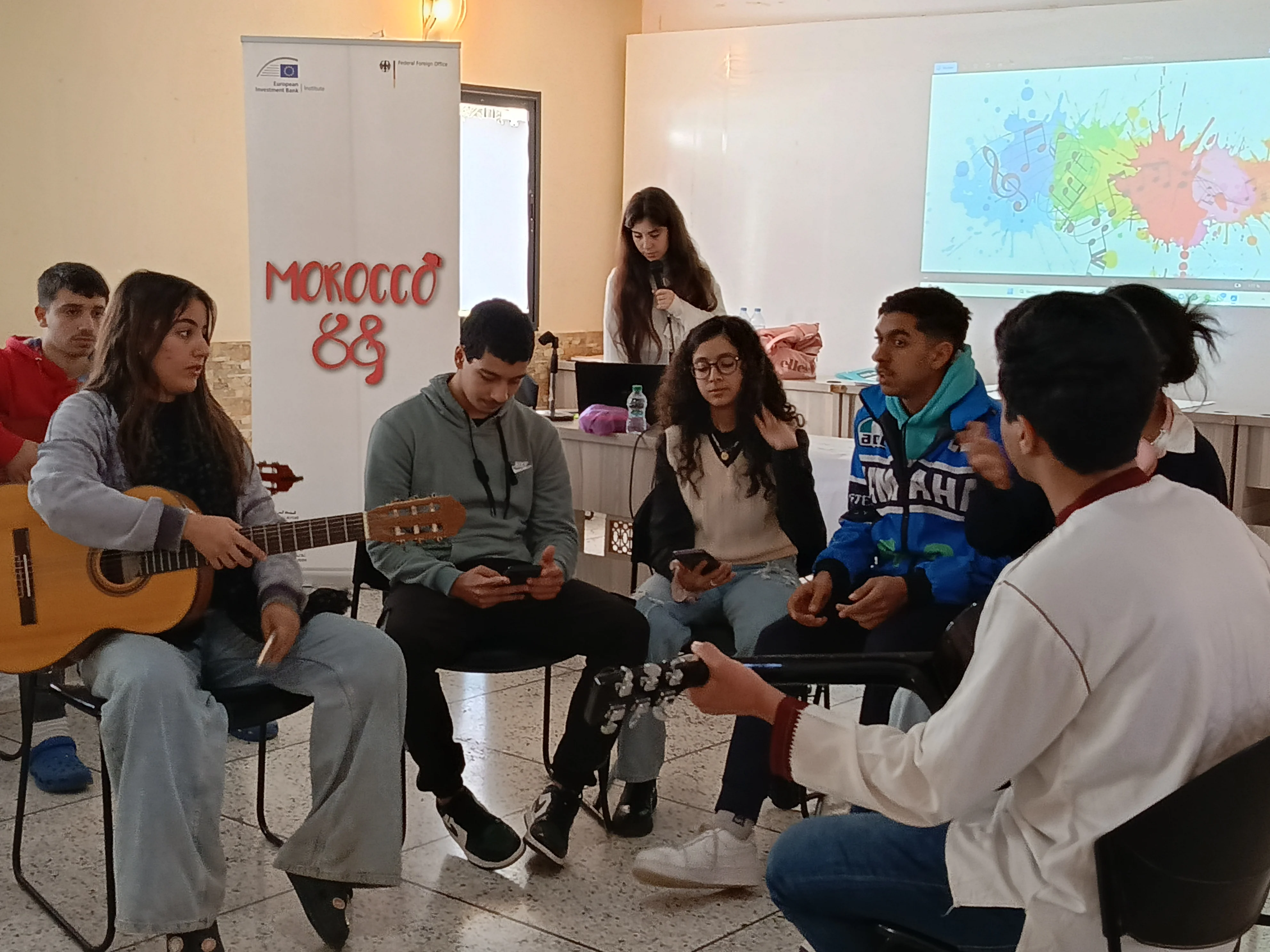 Morocco88 club members playing guitar together during a club session