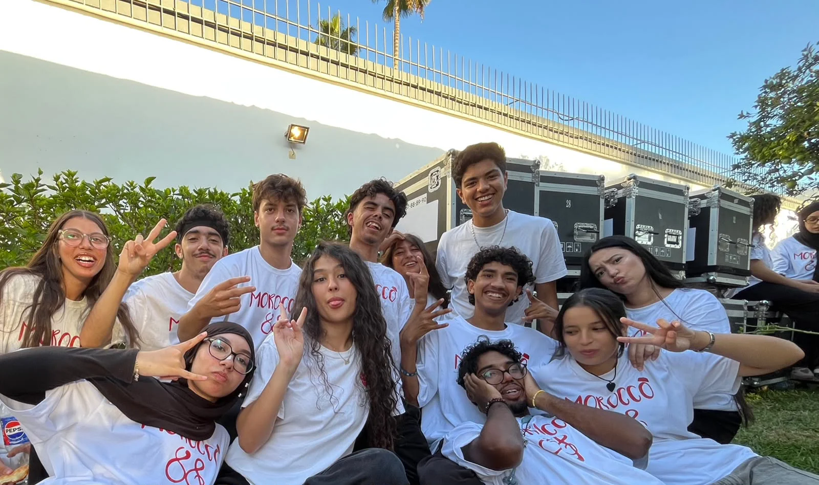 Young people in Morocco88 shirts sitting together outdoors