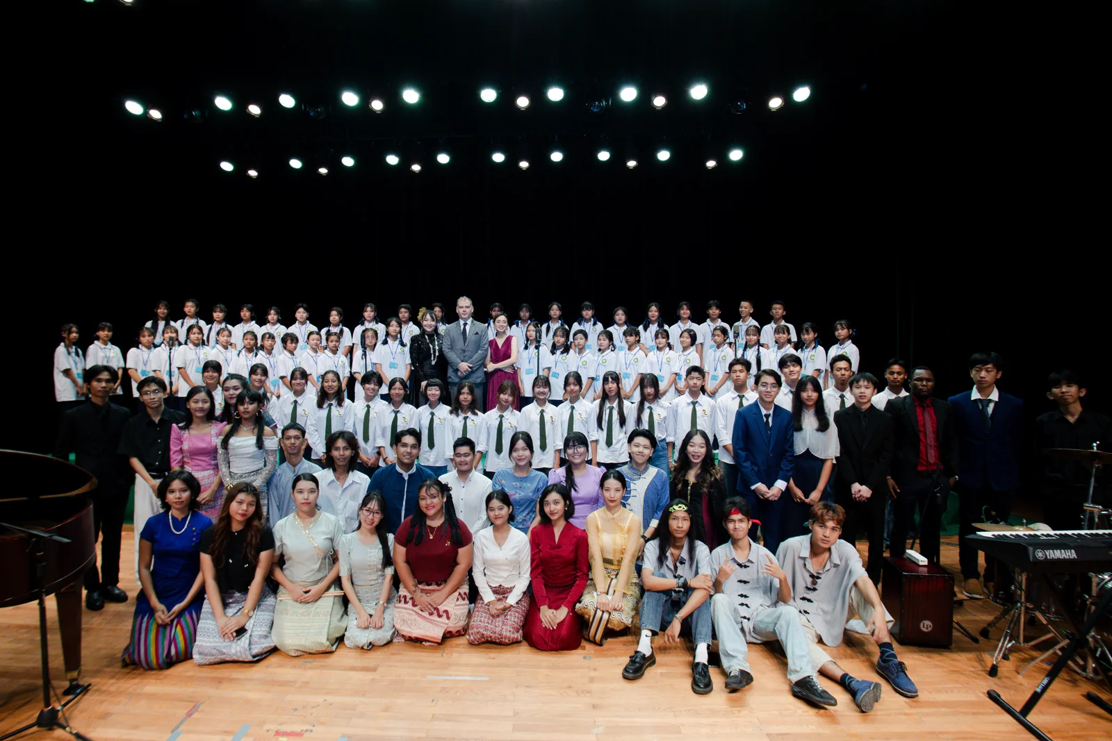 Festival performers gathered for a group photograph on the National Theatre stage